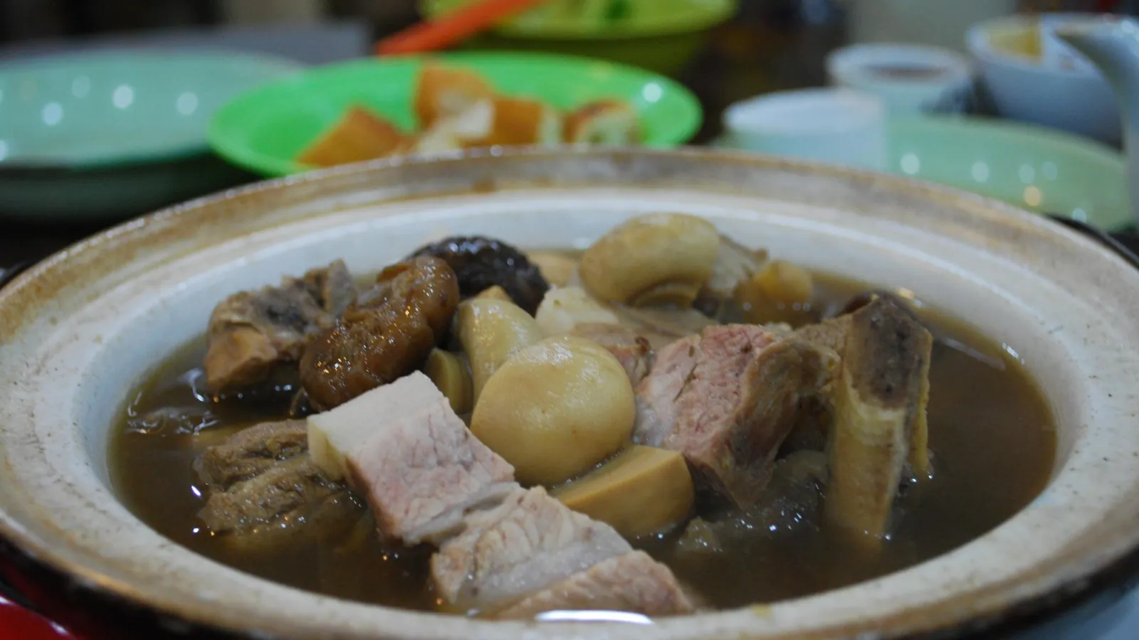 Claypot of bak kut teh with pork ribs, mushrooms and tofu puffs at a bak kut teh shop in Malaysia