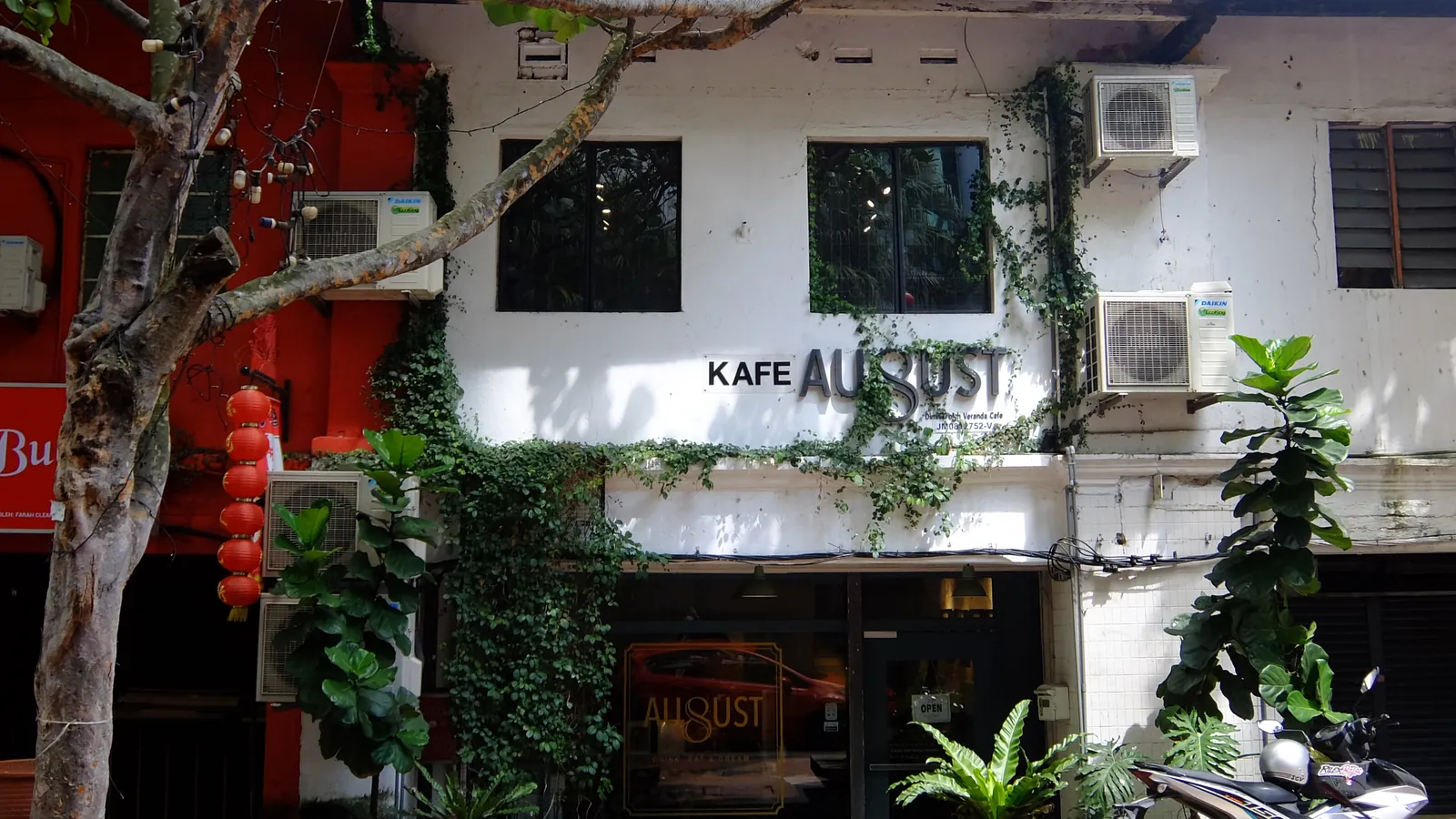 Plant-covered shophouse café with lanterns outside in Johor Bahru’s old Chinatown quarter