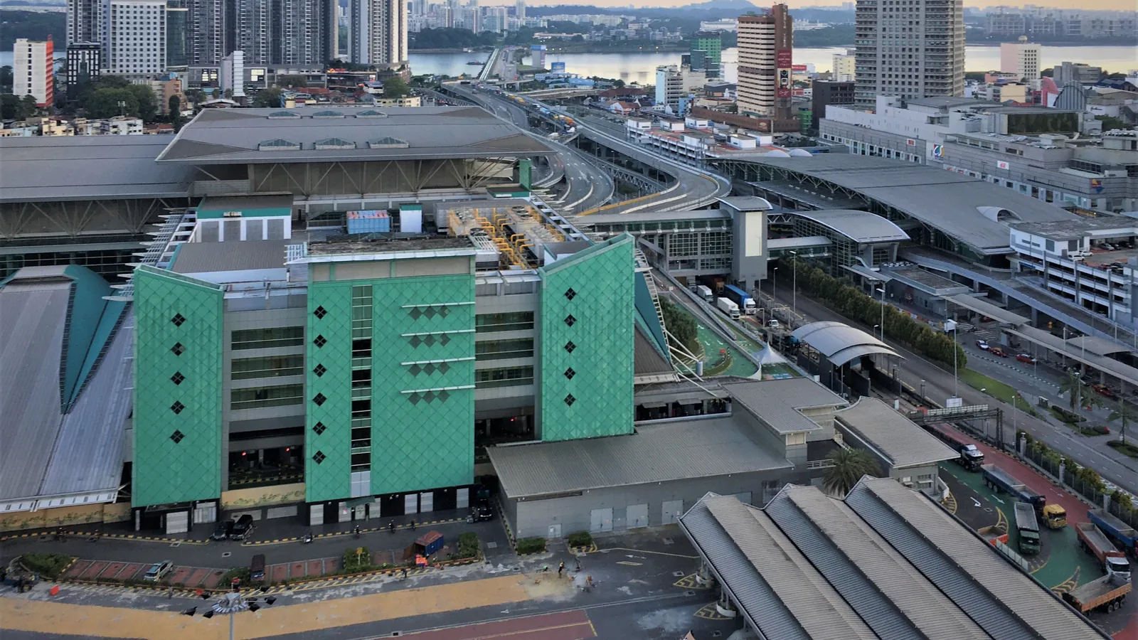 The Bangunan Sultan Iskandar immigration complex in Johor Bahru seen from above, with the Causeway and city buildings behind