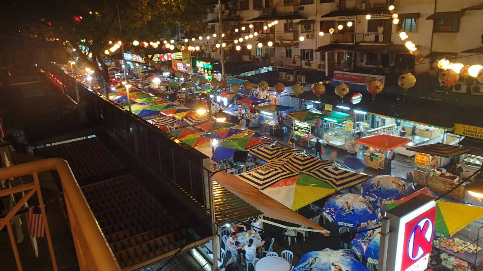 Jalan Alor food street in Bukit Bintang at night, with colourful umbrellas, hawker stalls and paper lanterns