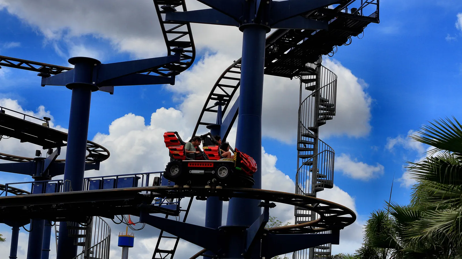 A red roller coaster car on blue steel track at Legoland Malaysia Resort in Iskandar Puteri, Johor