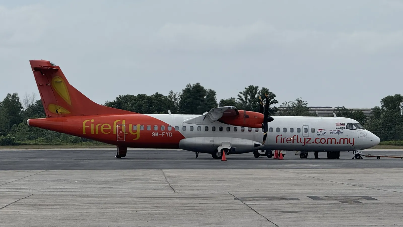 Firefly ATR 72 turboprop parked on the apron at Senai International Airport in Johor