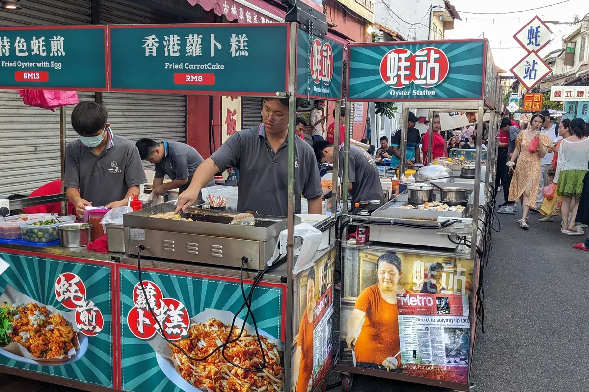 Food stall cooking oyster omelette at Jonker Street Night Market, Melaka