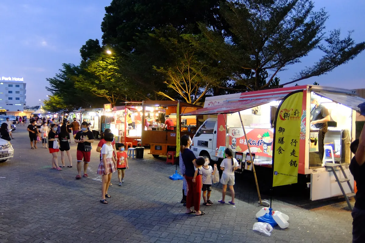 Families browsing food trucks at dusk in Mount Austin, Johor Bahru